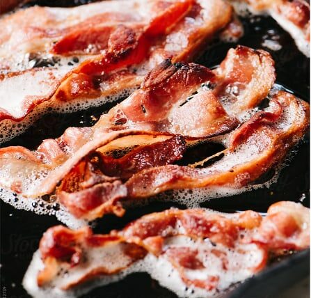 bacon sizzling in skillet