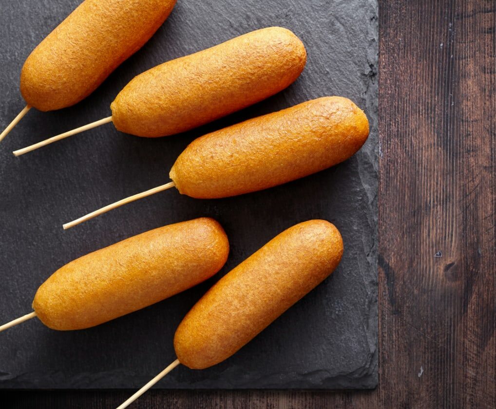 corndogs on a slate board