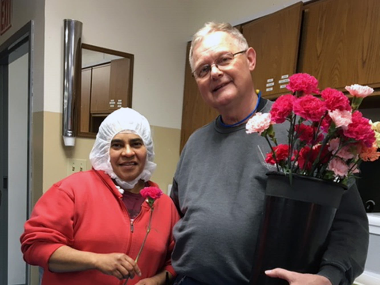 Chandler employees hand out carnations to all the mothers on Mother's Day